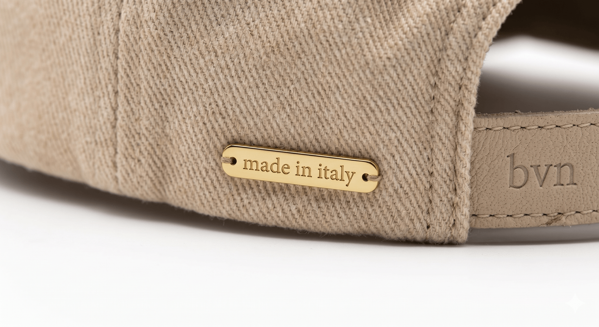 The MCMXCII Signature Cap — detail of the gold-toned made in italy hardware bar